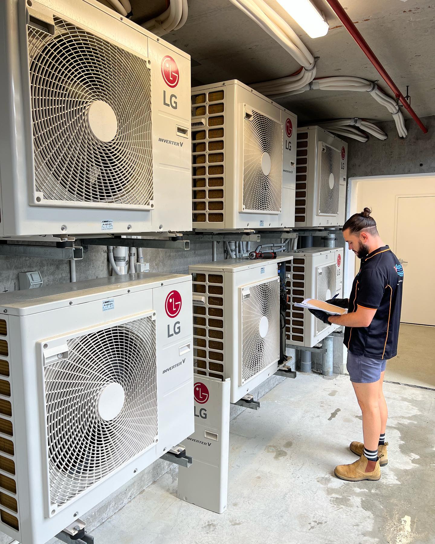 split system service Gold Coast specialist checking outdoor air conditioning unit before summer