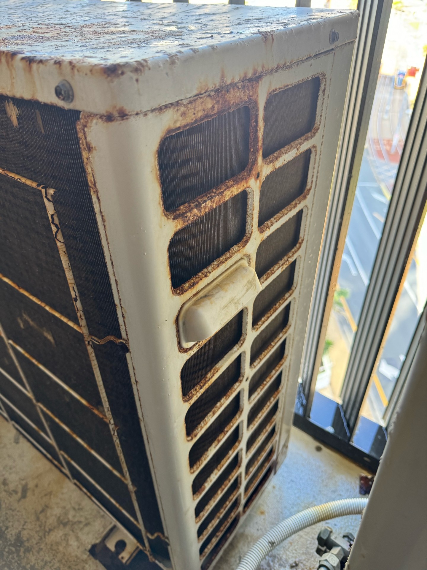 Gold Coast aircon rust - corroded outdoor unit at a Gold Coast home