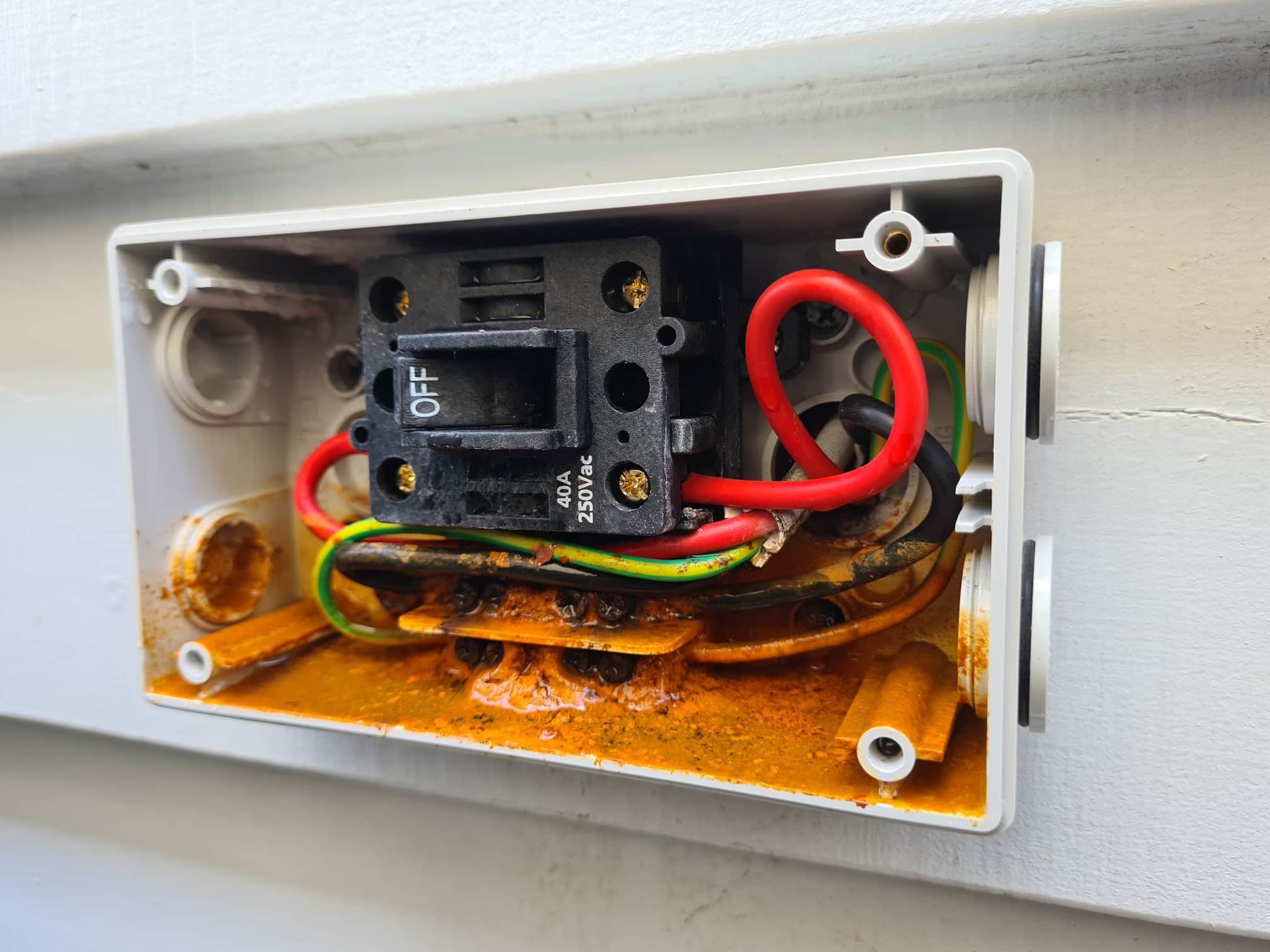aircon tripping breaker Gold Coast specialist checking outdoor air conditioning unit after electrical fault