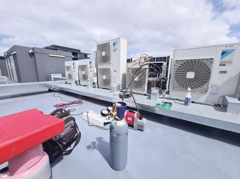 warranty air conditioning Gold Coast rooftop Daikin units being checked by air conditioning specialist