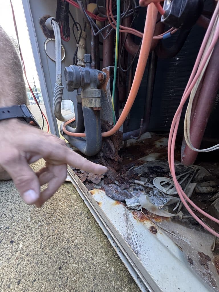 Daikin Service Gold Coast showing internal corrosion inside an outdoor Daikin ducted air conditioning unit