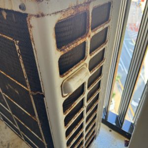 Gold Coast aircon rust - corroded outdoor unit at a Gold Coast home