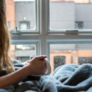 aircon not heating Gold Coast — a homeowner wrapped in a blanket on a cool winter morning, wondering why the house feels cold