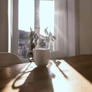 aircon winter Gold Coast — a Gold Coast homeowner considering their morning comfort on a cool winter day